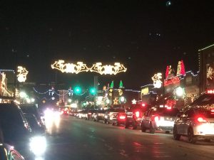 Christmas lights on old buildings on Main Street, with lights also hanging over the street.