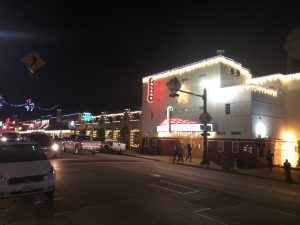 An old movie theater outlined in Christmas lights.